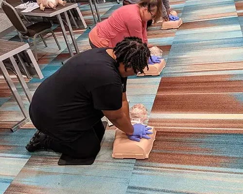 People giving chest compressions